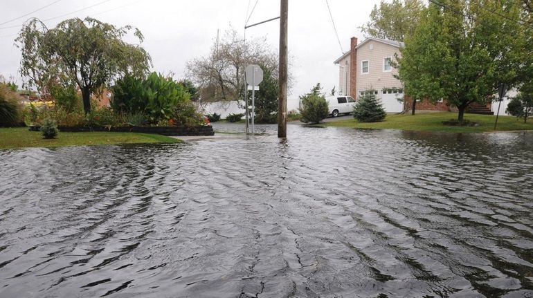 West Lake Drive in Lindenhurst is flooded on Oct. 18,...