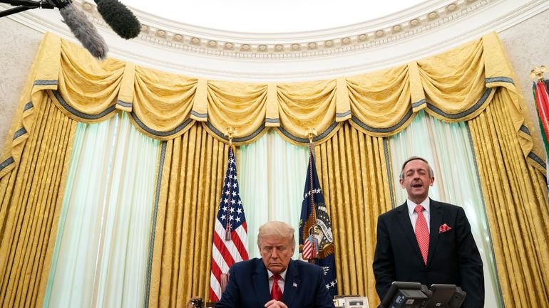 Pastor Robert Jeffress and President Donald Trump pray after Trump...