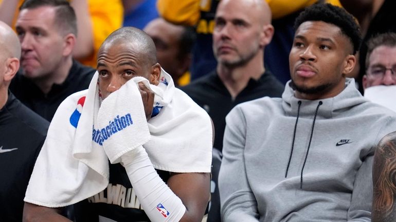 Milwaukee Bucks forward Khris Middleton (22) watches from the bench...