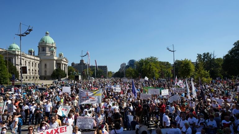 People attend a protest against pollution and the exploitation of...