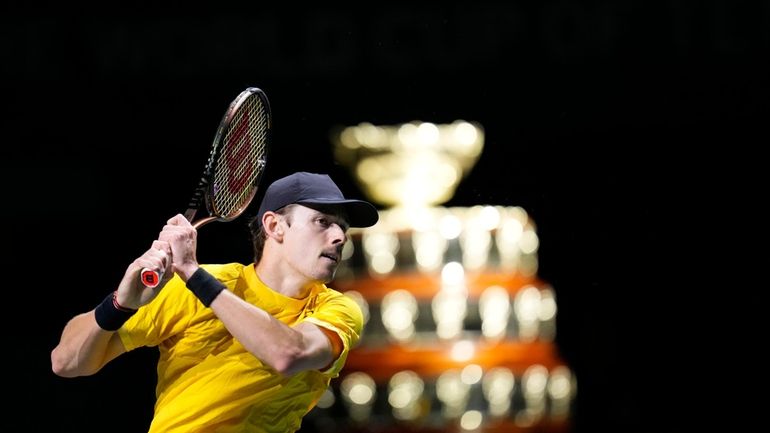 Australia's Alex de Minaur returns the ball to Finland's Emil...