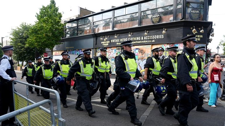 Police officers on Ladbroke Grove as the Notting Hill Carnival...