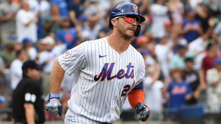 Mets first baseman Pete Alonso rounds the bases on his...