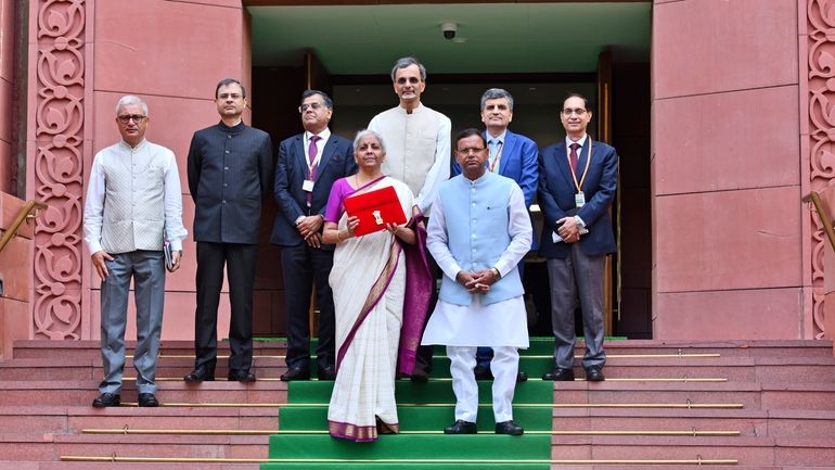 Indian Finance Minister Nirmala Sitharaman, carrying a red bag containing...