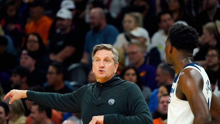 Minnesota Timberwolves head coach Chris Finch, left, talks with Timberwolves...