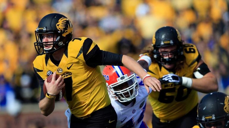 Missouri quarterback Maty Mauk (no. 7) carries the ball upfield...