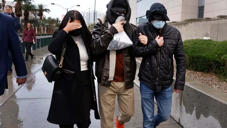 Former FBI informant Alexander Smirnov, center, leaves the courthouse on...