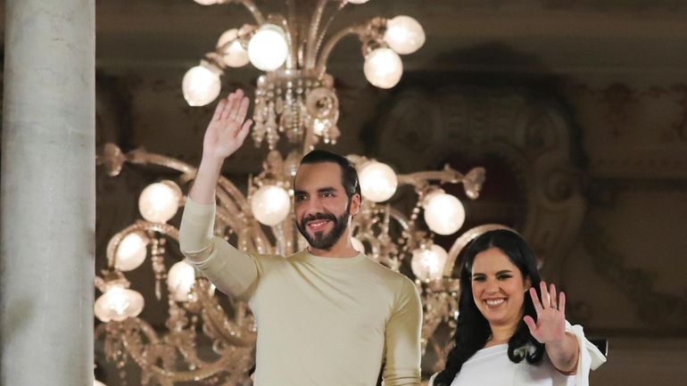 El Salvador President Nayib Bukele, left, accompanied by his wife...