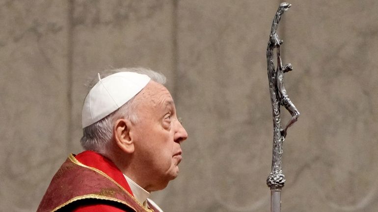 Pope Francis holds the pastoral staff as he presides over...