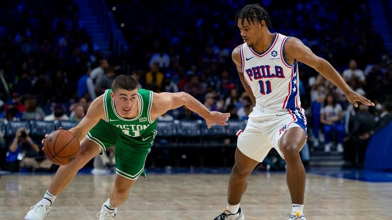 Boston Celtics' Payton Pritchard, left, drives against Philadelphia 76ers' Jaden...