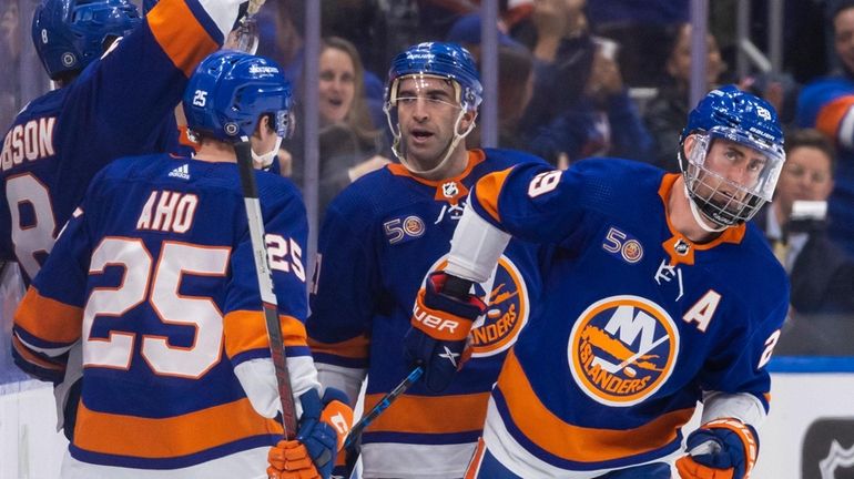 New York Islanders center Brock Nelson skates toward the bench...