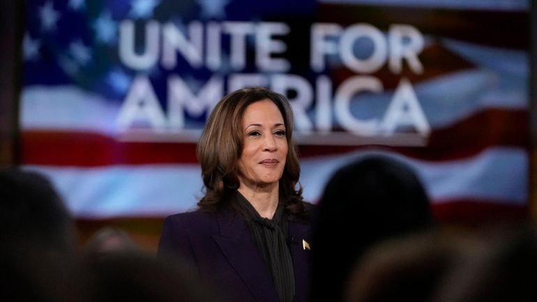 Democratic presidential nominee Vice President Kamala Harris listens as she...