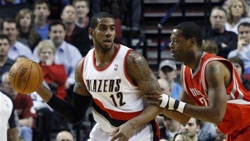 Portland Trail Blazers forward LaMarcus Aldridge, left, looks to pass...