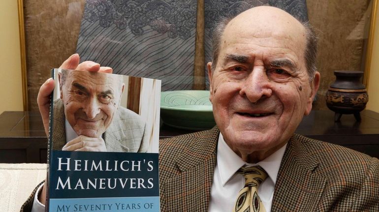 In this Feb. 5, 2014 photo, Dr. Henry Heimlich holds...