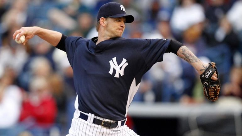 New York Yankees starting pitcher A.J. Burnett throws in the...