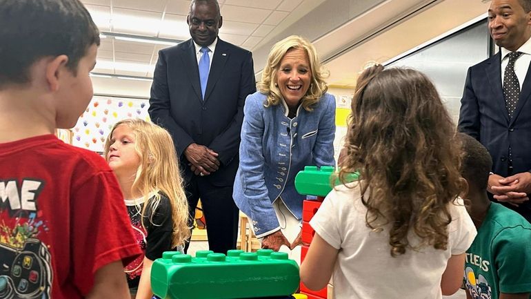 First lady Jill Biden, center, and Defense Secretary Lloyd Austin,...