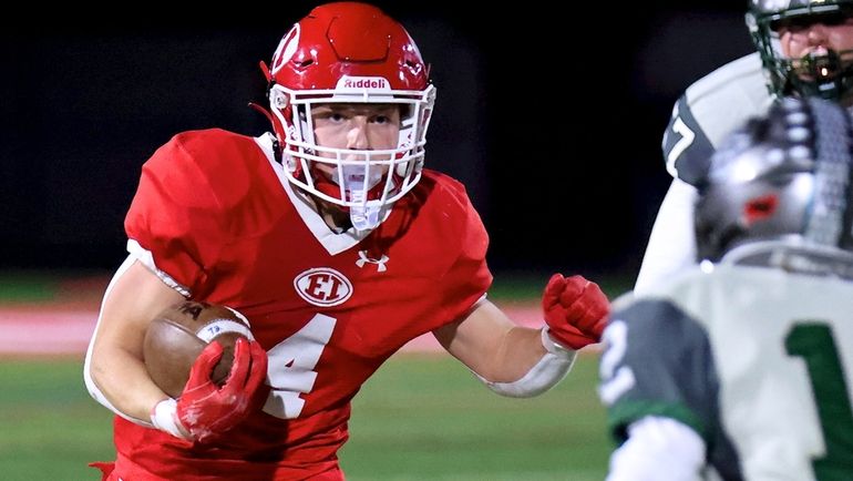 East Islip RB Ryan Parker takes the handoff to the...