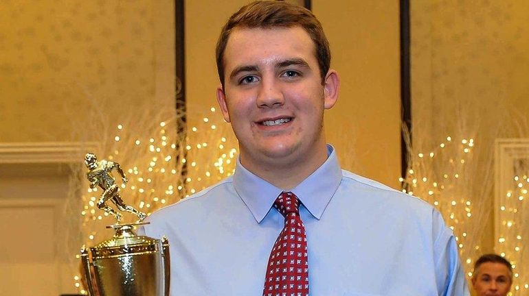 Shoreham-Wading River's Ethan Wiederkehr poses with the Zellner Award during...