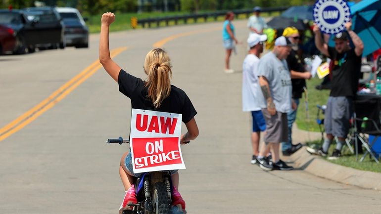 Lear production worker Abigail Fletcher rides her mini bike in...