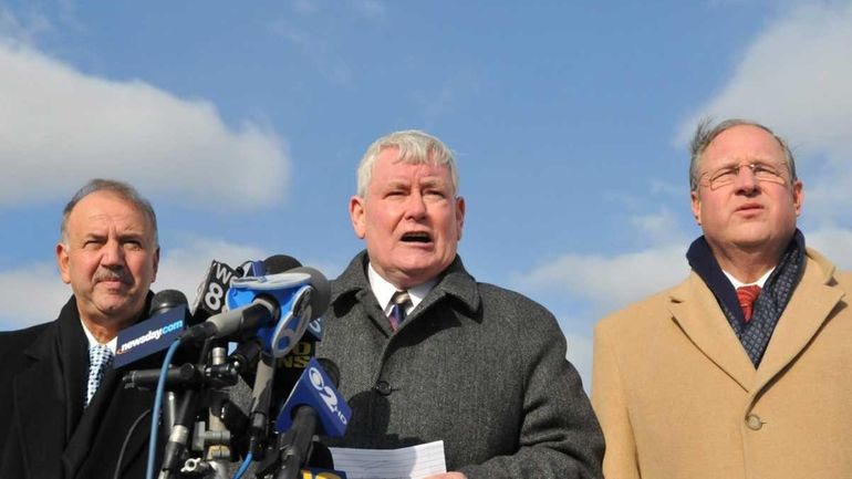 Flanked by Chief of Detectives Dominick Varrone, left, and Chief...