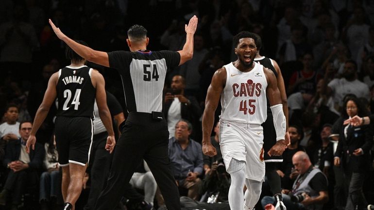 Cleveland Cavaliers guard Donovan Mitchell reacts after Nets guard Cam...