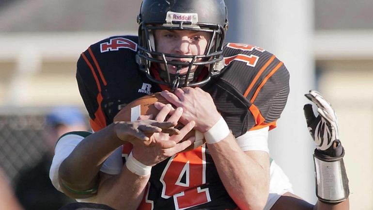 Babylon's Jake Carlock pulls in a pass in front of...