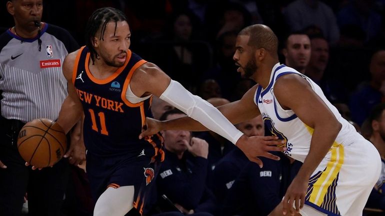 Jalen Brunson of the Knicks controls the ball against Chris...