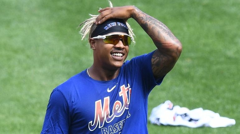 New York Mets starting pitcher Marcus Stroman looks on during...