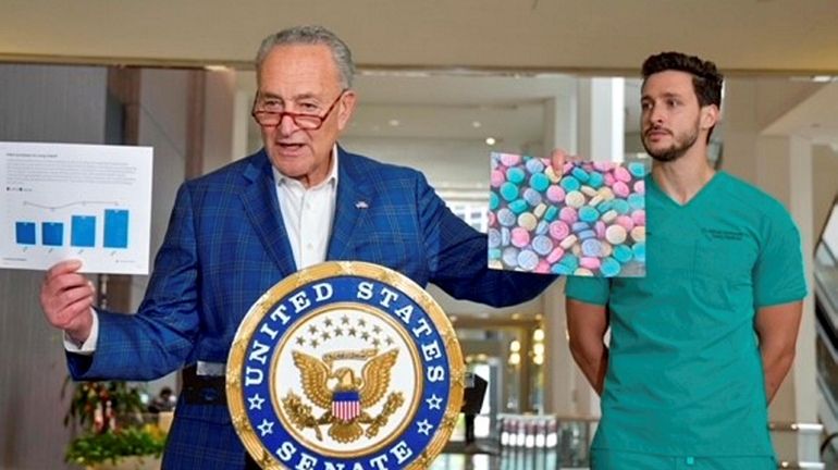 Sen. Chuck Schumer, holding a photo of Rainbow Fentanyl is...