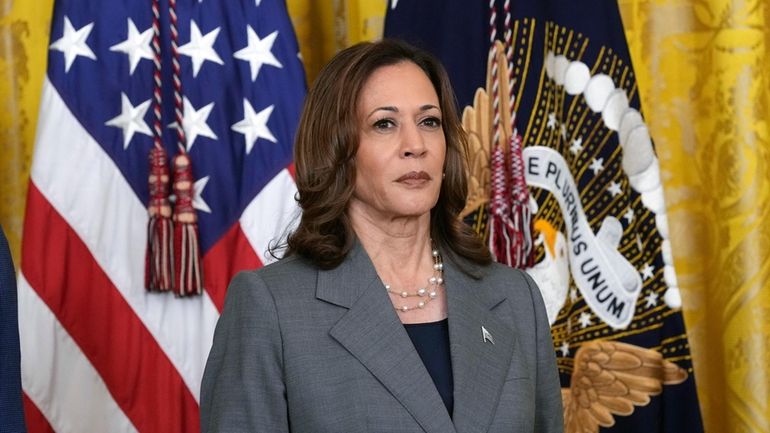 Vice President Kamala Harris listens during an event with President...