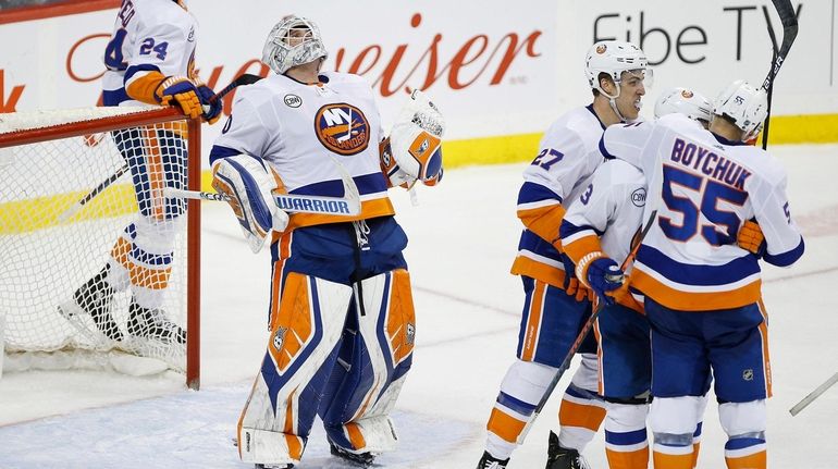 Islanders goaltender Robin Lehner celebrates after the Islanders defeated the...