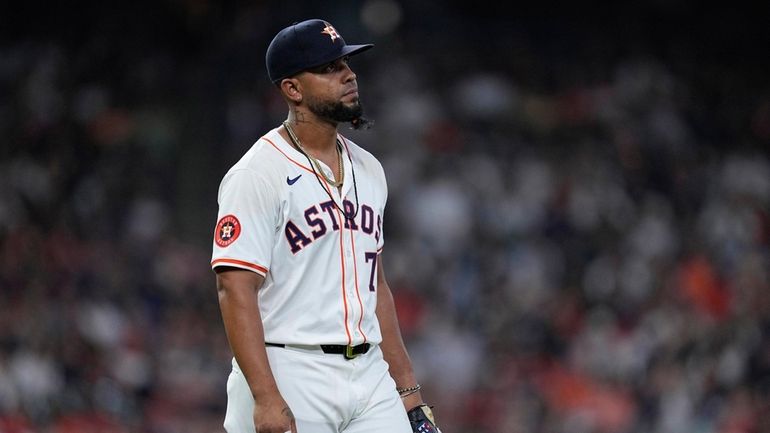 Houston Astros first baseman Jose Abreu reacts after committing a...