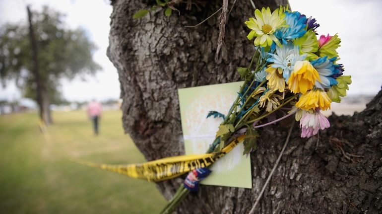 Flowers are left in front of Santa Fe High School...