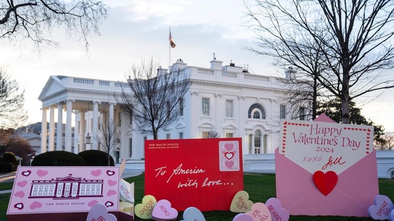 Decorations for Valentine's Day adorn the White House lawn, Wednesday,...