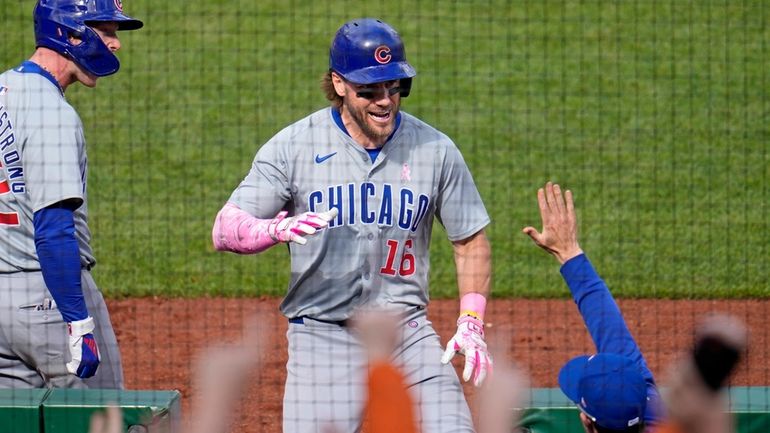 Chicago Cubs' Patrick Wisdom (16) returns to the dugout after...