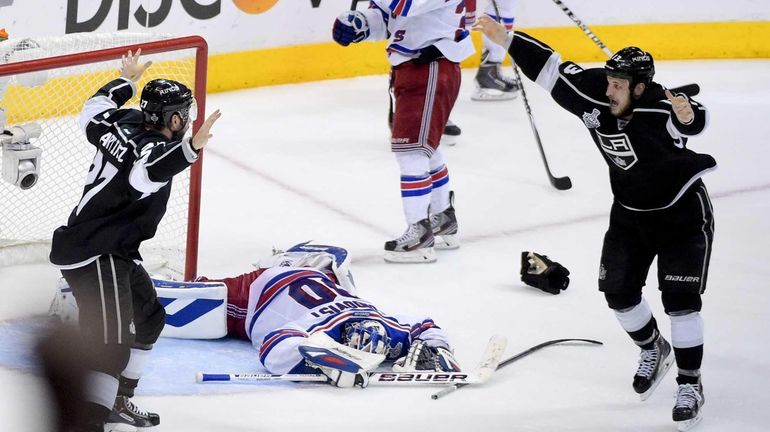 Los Angeles Kings defenseman Alec Martinez, left, celebrates after scoring...