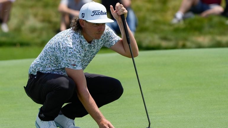 Australia's Cam Smith lines up his putt on the ninth...