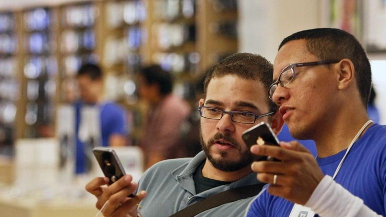 Duane Davis, left, learns about the new features of the...