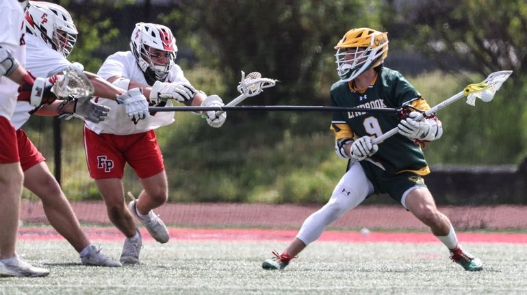 Lynbrook's Jack LaBarbera is triple teamed during a Nassau Conference...