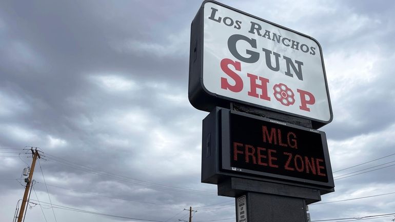 The marquee at a gun shop in Los Ranchos, N.M,...