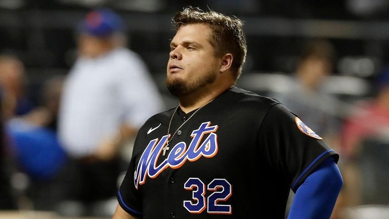 Daniel Vogelbach of the Mets walks off the field after...