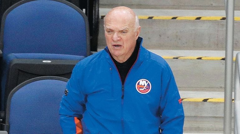 Islanders general manager Lou Lamoriello watches his team during practice...