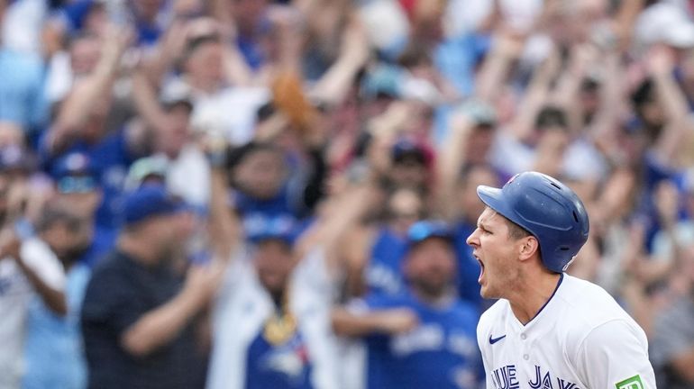 Toronto Blue Jays' Daulton Varsho celebrates after hitting a RBI...