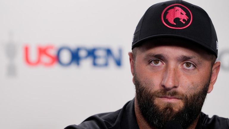 Jon Rahm, of Spain, speaks during a news conference at...