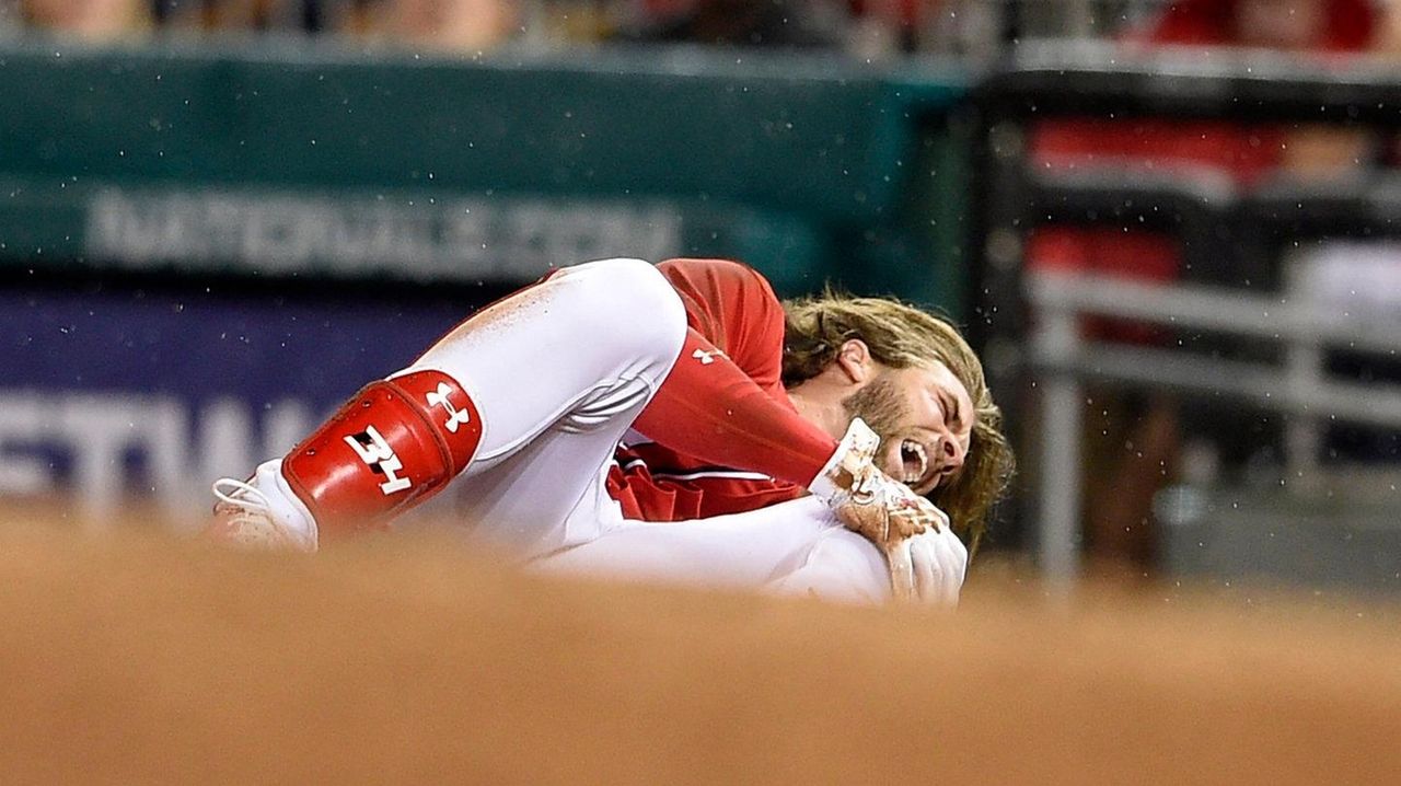 Bryce Harper injury came after a 3-hour delay and heavy rainfall in  Washington 