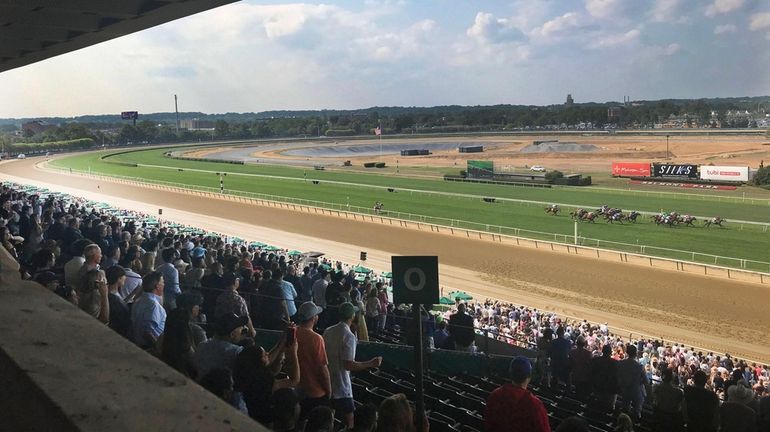 Spectators fill the Belmont Park grandstand for the horse races preceding...