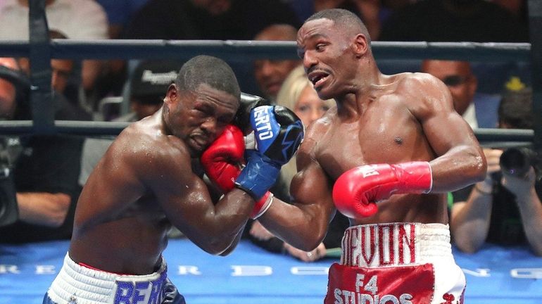 Devon Alexander lands an uppercut to the face of Andre...