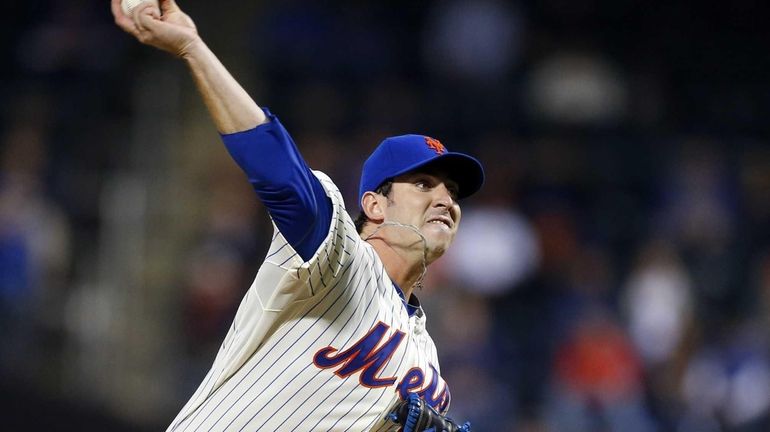 Matt Harvey of the Mets delivers a pitch against the...