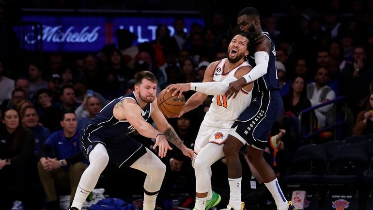 Luka Doncic #77 and Tim Hardaway Jr. #11 of the...