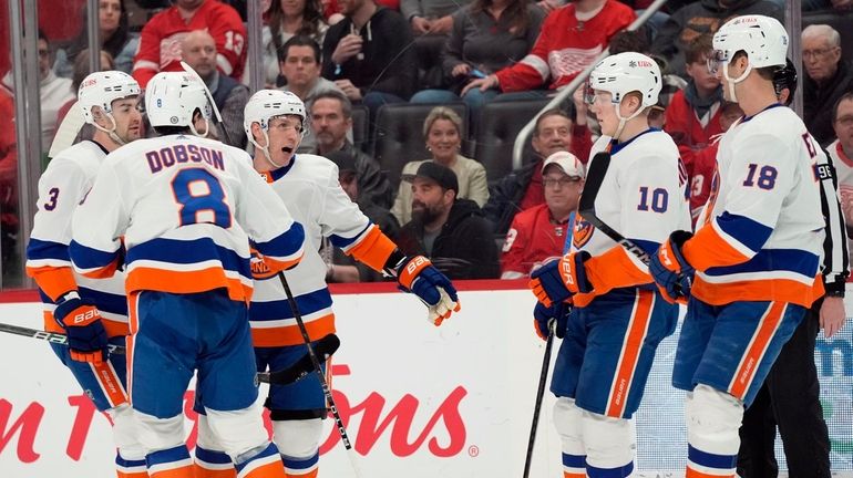 Islanders center Casey Cizikas, third from left, celebrates his goal...